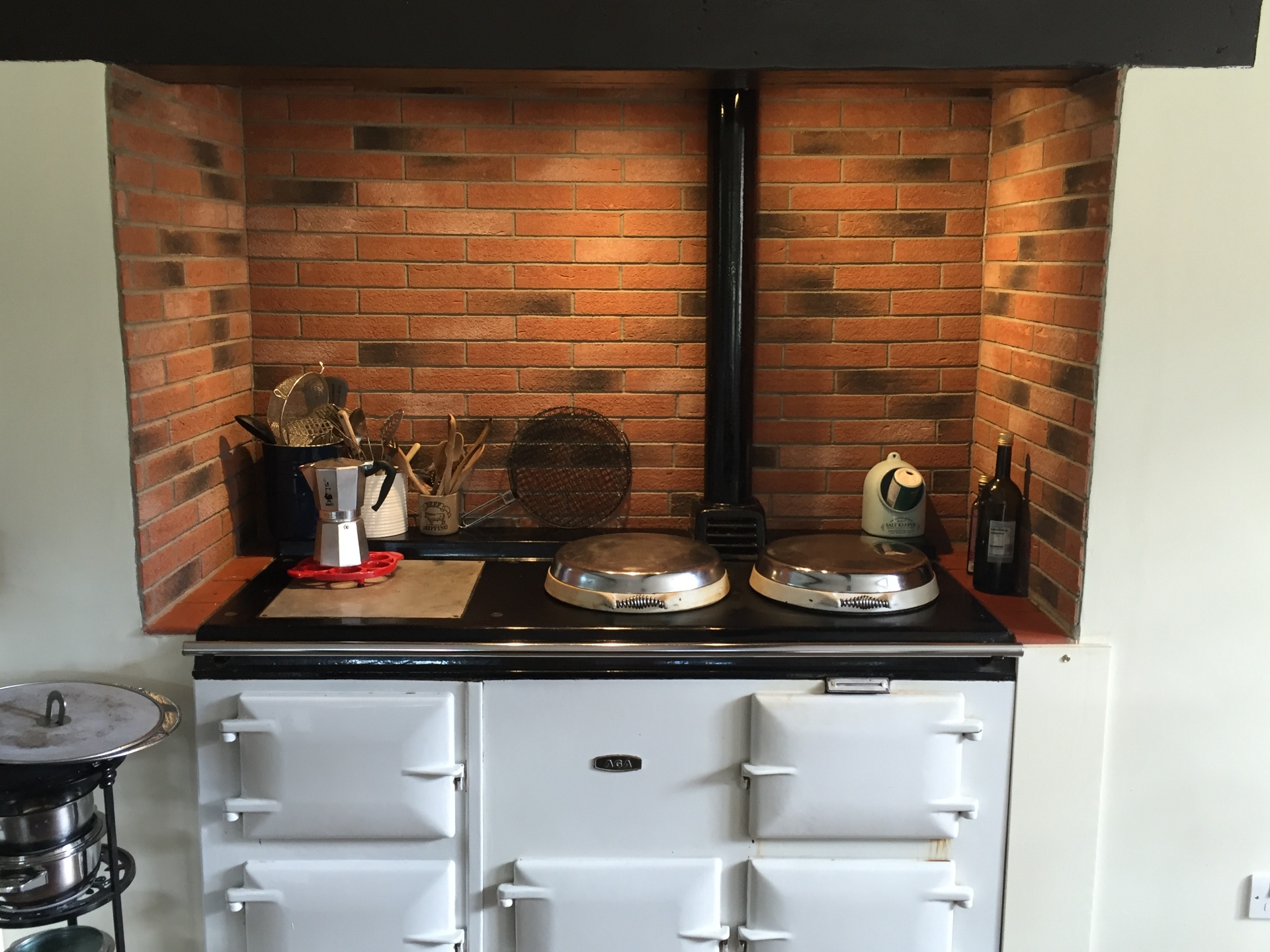 The cream Aga set into the original brick inglenook